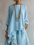 Top Asimmetrico Blu e Pantaloni Floreali a Gamba Larga