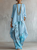 Top Asimmetrico Blu e Pantaloni Floreali a Gamba Larga