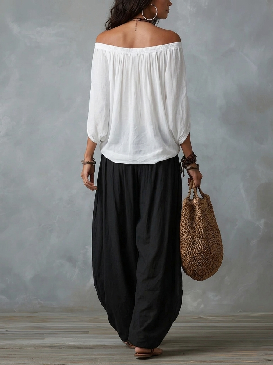 Top bianco con spalle scoperte e set di pantaloni lanterna larghi