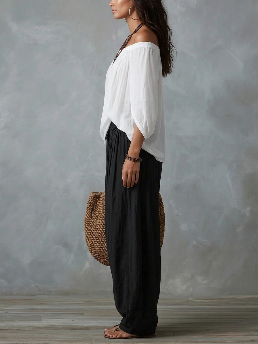 Top bianco con spalle scoperte e set di pantaloni lanterna larghi