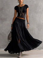 Completo top in pizzo nero trasparente e gonna lunga plissettata